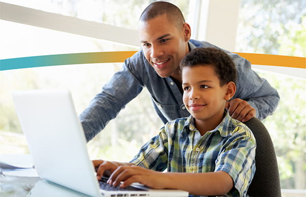 Father and son looking at computer