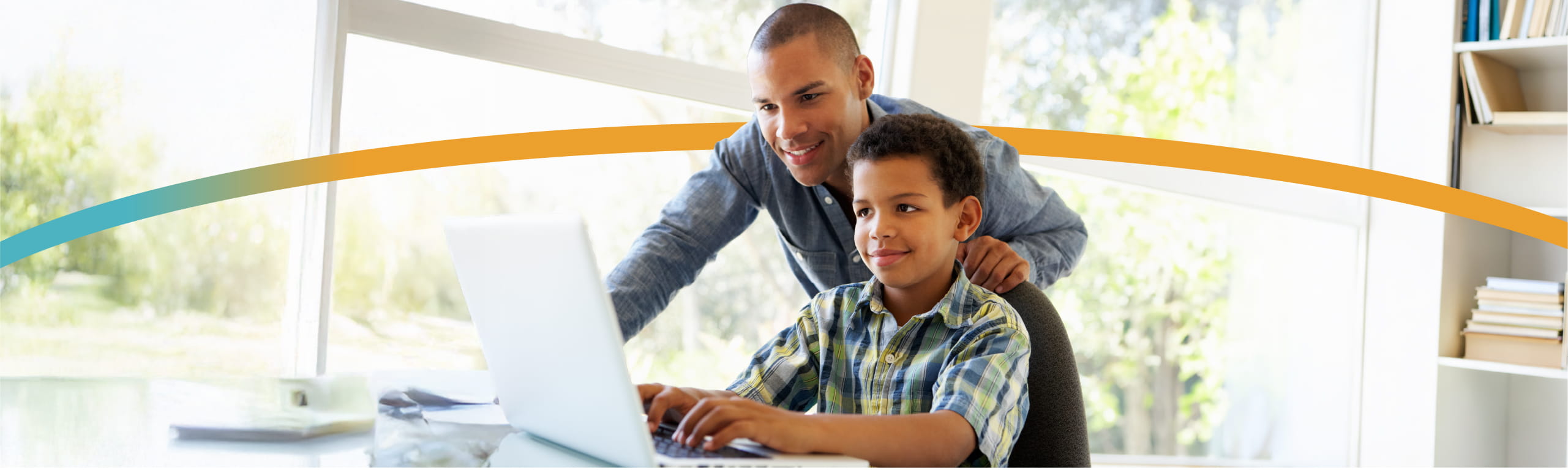 Father and son looking at computer